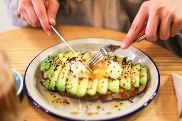 breakfast of avocado toast with egg and coffee with milk