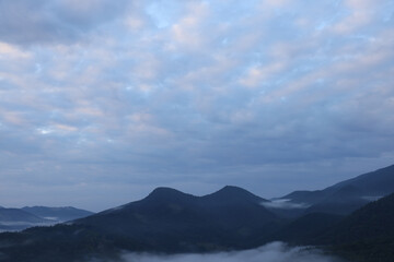 Picturesque view of mountains covered with fog