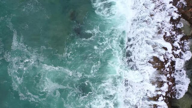 Aerial view of waves splashing on beach