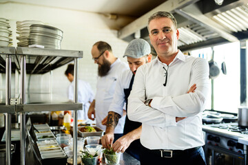 Fototapeta na wymiar Restaurant kitchen chef with staff and manager