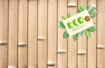 Horizontal background with eco paper label and green leaves on bamboo mat