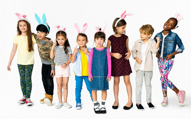 Fototapeta premium Group of Kids Wearing Bunny Ears for Easter Happiness Smiling on White Blackground