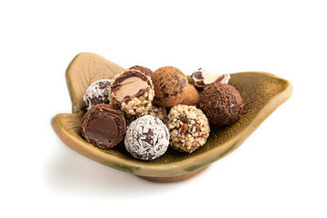 Chocolate truffle candies isolated on white background. side view, close up.