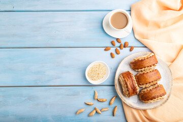 Traditional armenian dessert gata with cup of coffee on a blue wooden background. top view, copy space.