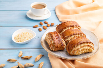 Traditional armenian dessert gata with cup of coffee on a blue wooden background. side view, close up.