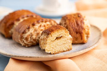Traditional armenian dessert gata with cup of coffee on a blue wooden background. side view, close up, selective focus.