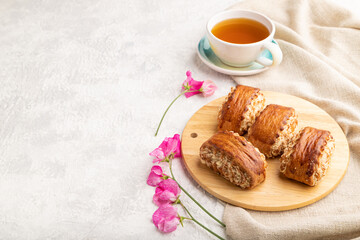 Traditional armenian dessert gata with cup of green tea on a gray concrete background. side view, copy space.