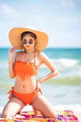 Young pretty sexy asian woman in bikini on tropical beach. summer vacation.