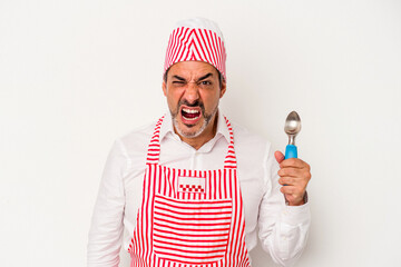 Middle age caucasian ice maker caucasian man holding a spoon isolated on white background  screaming very angry and aggressive.