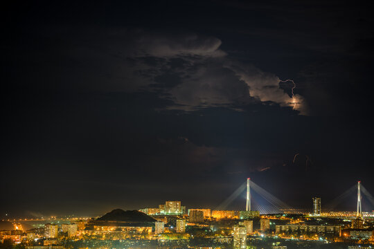 Lightning storm at night over city.