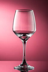 pouring red wine into glass with highlights on red background