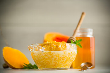 sweet boiled pumpkin porridge in a bowl with honey