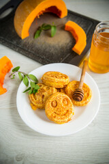 sweet lush pumpkin pancakes with honey in a plate