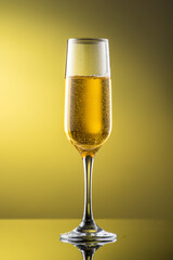 tall champagne glass with highlights on yellow background