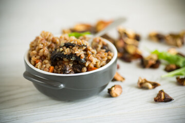 boiled buckwheat with vegetables and dried forest mushrooms in a ceramic mold