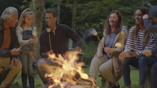 Long Shot Of Family Sitting Around Campfire 02