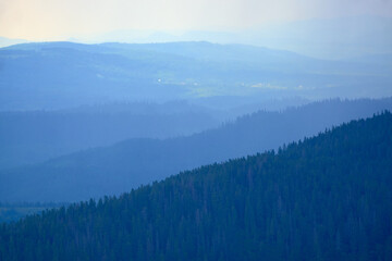 Scenic shot of layers of mountains in bluish tint