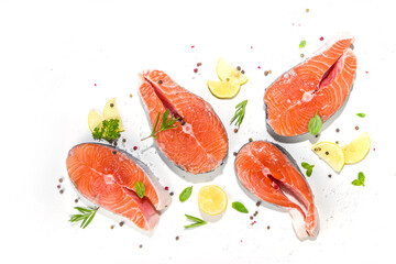 Set of fresh ready for cooking raw salmon steaks, red fish portioned slices with salt and spices, on white table background top view copy space1