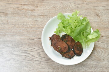 fried textured vegetable protein vegetarian food with chili and green oak on plate