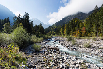 Fototapeta na wymiar Oberstdorf- View to creek Stillach and in the distance View the mountain in autumn mood