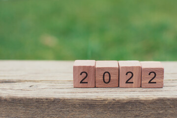 Text written to column of wooden blocks, number 2022 in new year card congratulation concept with copy space