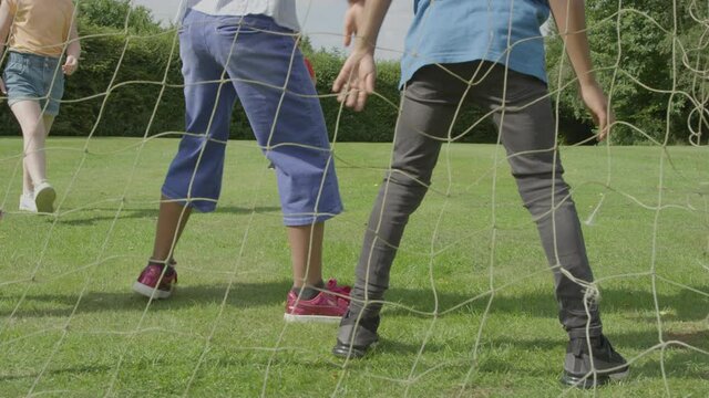 Handheld Shot Goal Net as Children Play Football