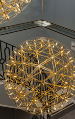 A lamp in the form of balls in close-up on a flight of stairs