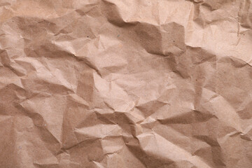 Texture of wrinkled kraft paper bag as background, closeup