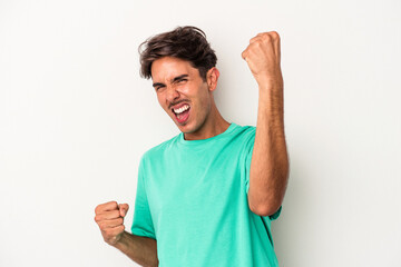 Young mixed race man isolated on white background cheering carefree and excited. Victory concept.