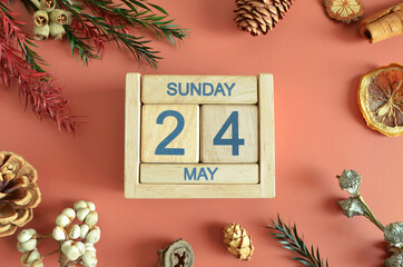 May 24, Cover design with calendar cube, pine cones and dried fruit in the natural concept.