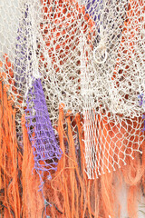 A close-up of colorful fishing nets on a boat