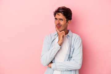 Young mixed race man isolated on white background unhappy looking in camera with sarcastic expression.