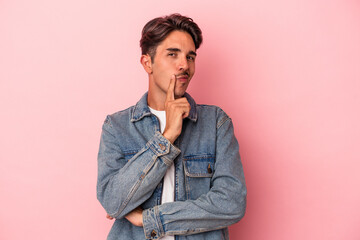 Young mixed race man isolated on white background looking sideways with doubtful and skeptical expression.