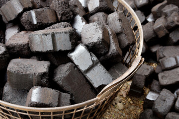 Closeup view of black charcoal, coal briquets. Energy resource, heating, industrial use.