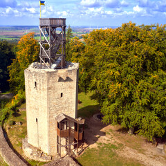 more than 1000 years old castle ruins with destroyed walls and a wooden viewing platform
