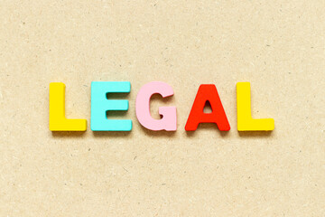 Color alphabet letter with word legal on wood background