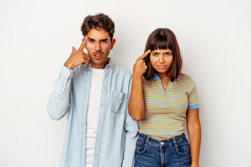 Young mixed race couple isolated on white background pointing temple with finger, thinking, focused on a task.