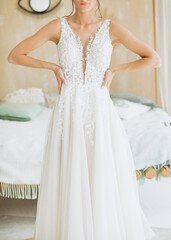 Pretty white wedding dress on the bride..Details of style and tailoring of a dress.
