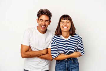 Young mixed race couple isolated on white background laughing and having fun.