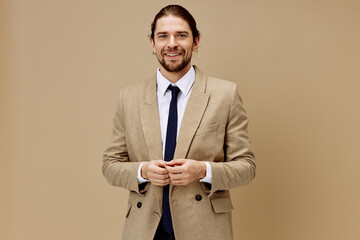 man in beige jacket in a suit with a tie posing isolated background