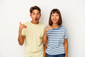 Obraz premium Young mixed race couple isolated on white background laughing about something, covering mouth with hands.