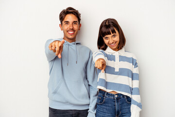 Fototapeta premium Young mixed race couple isolated on white background cheerful smiles pointing to front.