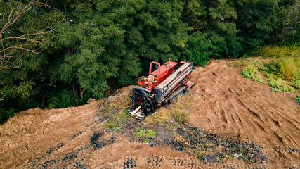 Horizontal directional drilling technology. Aerial view of Drilling machine work process....