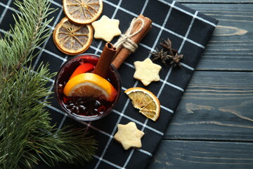 Hot winter cocktail, mulled wine on a wooden background. Top view, space for text.