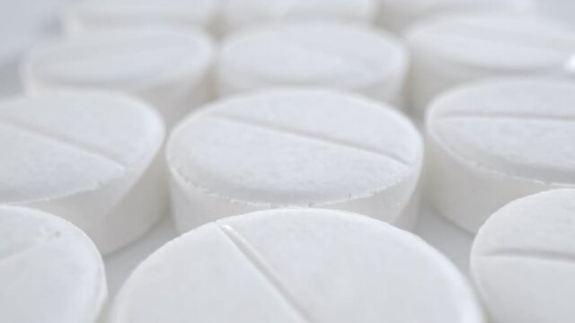 Macro shot of medications tablets drugs on a white soft background. Treatment pharmacology concept.