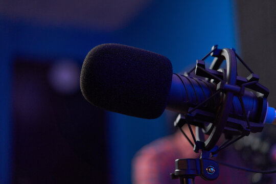 Microphone with tripod placed on table in dark studio