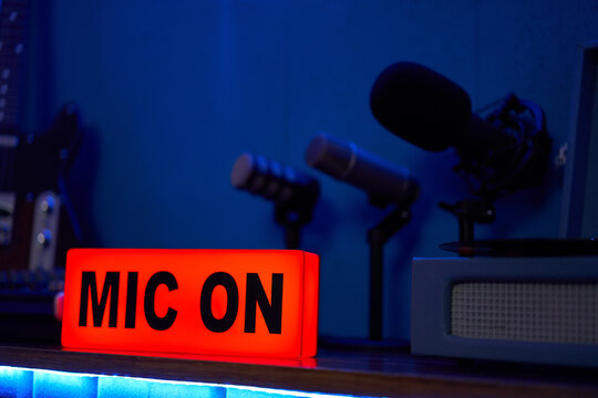 Microphones with tripod placed on table in dark studio