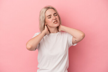 Young caucasian woman isolated on pink background suffering neck pain due to sedentary lifestyle.