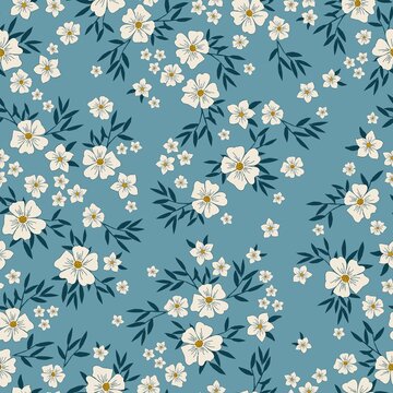Seamless vintage pattern. wonderful white flowers and dark blue leaves on a blue background. vector texture. trend print for textiles, wallpaper and packaging. © Алена Шенбель