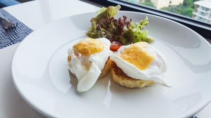 egg benedict on the white dish on table